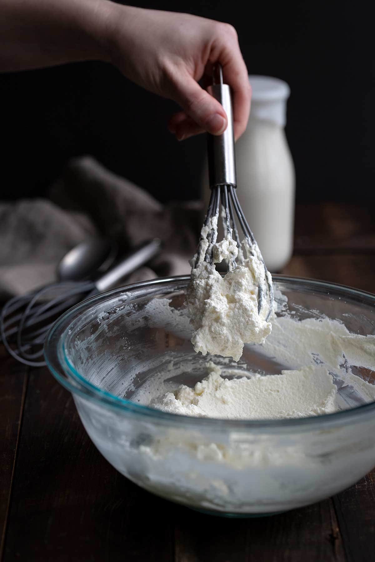 A whisk full of over-whipped cream