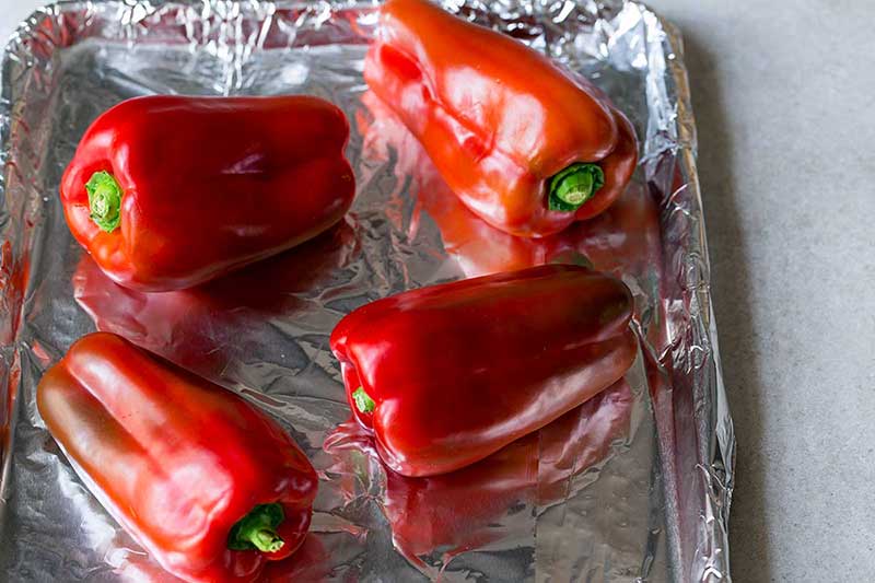 Red bell peppers on foil-lined sheet pan