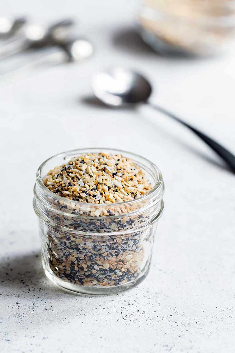 Everything bagel seasoning in mason jar with a spoon