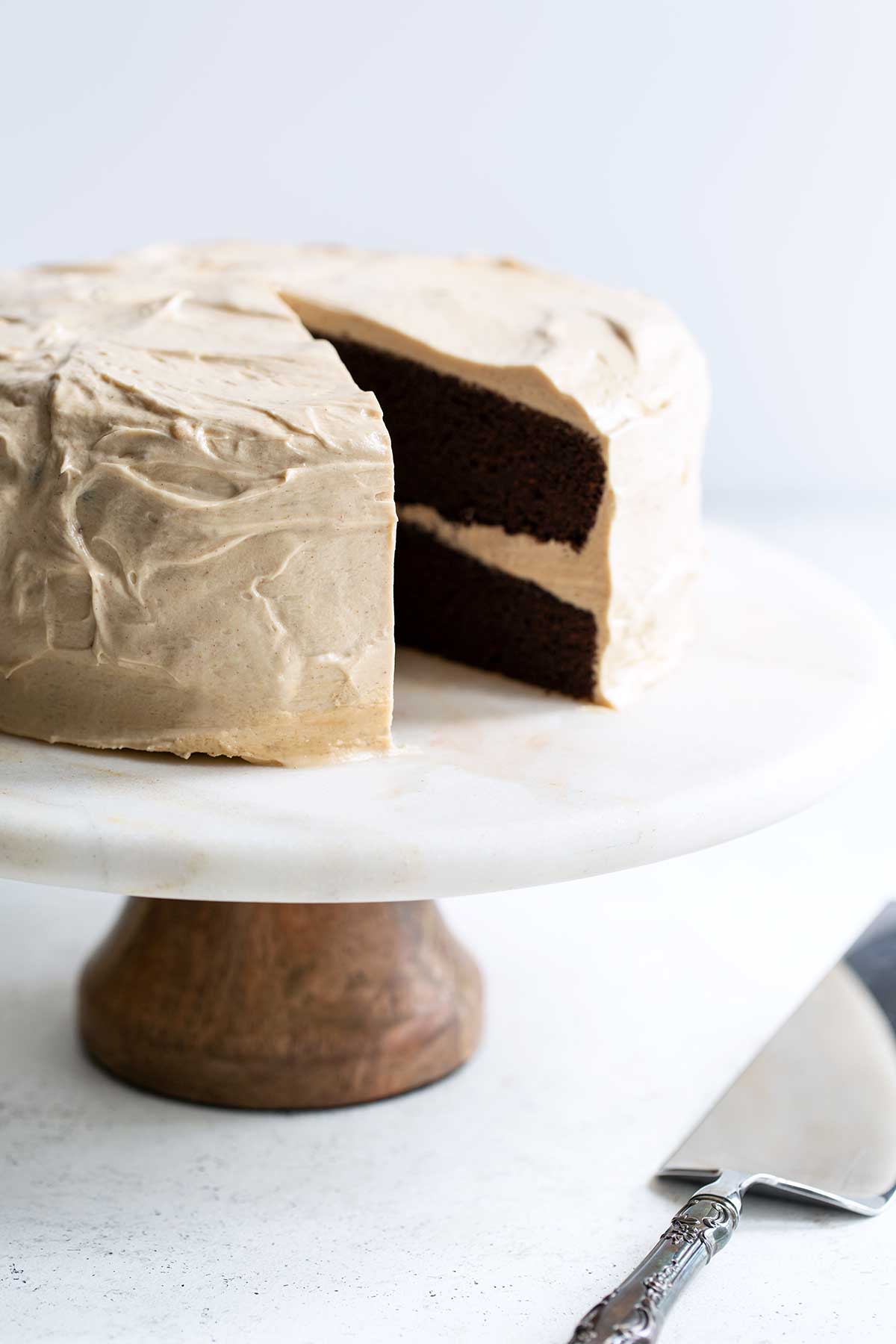 Layer cake on a cake stand with a slice missing