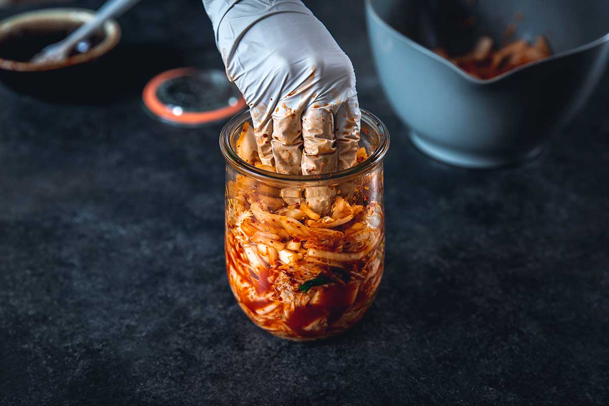 Packing kimchi in a jar to ferment