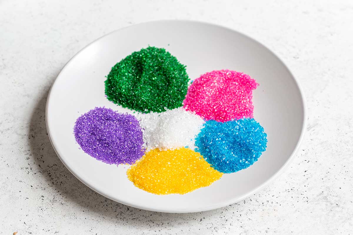 Different colors of sanding sugar on a plate