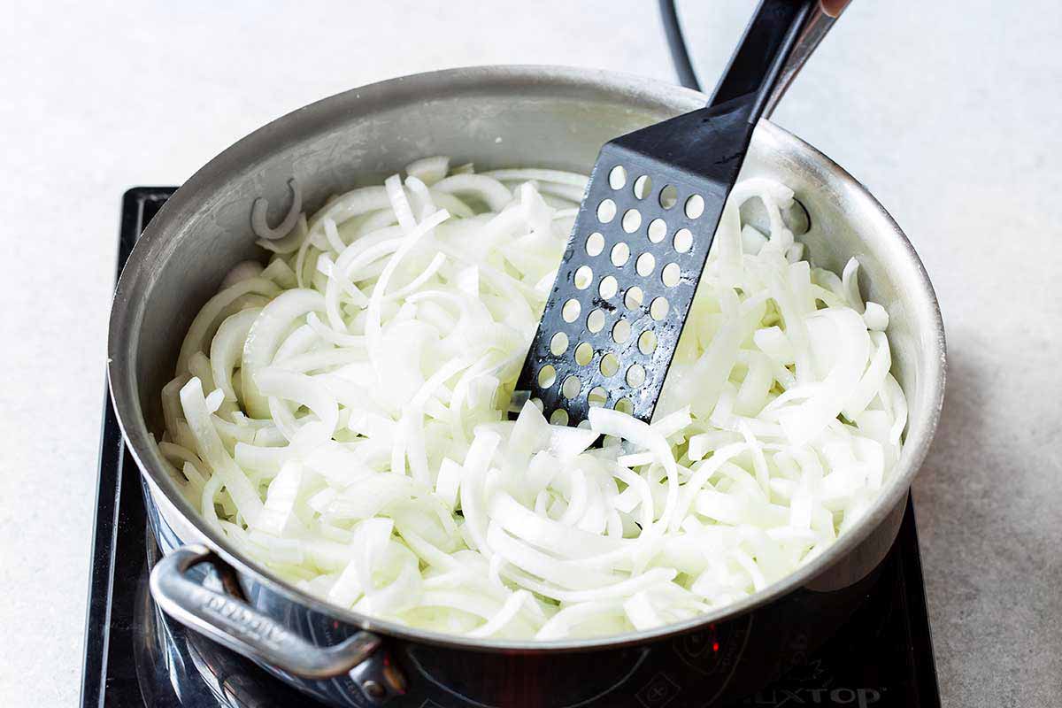 sliced yellow onions in pan