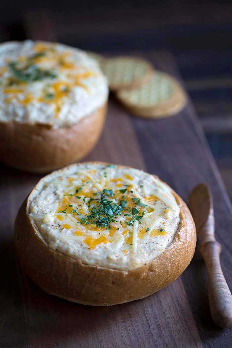 Hot crab dip fresh out of the oven, served in a bread bowl