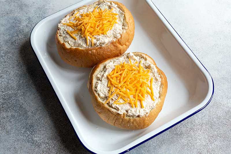 Cheese sprinkled over the hot crab dip prior to baking