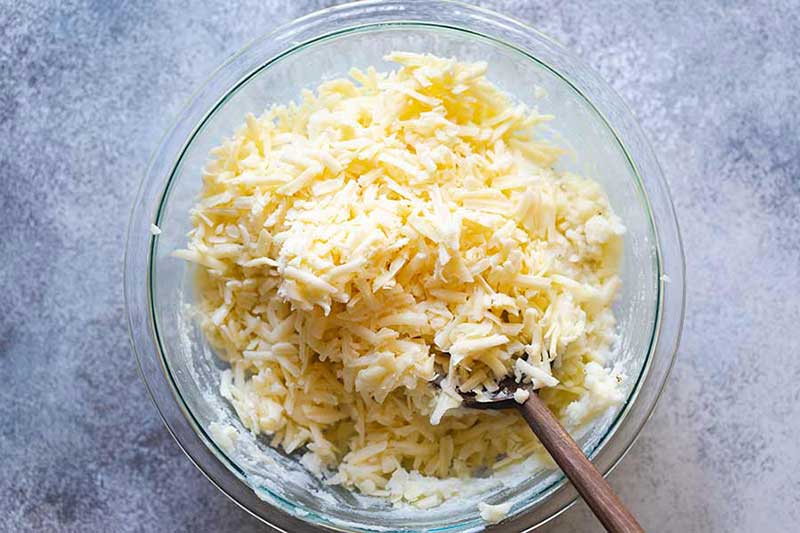 stirring cheese into mashed potatoes