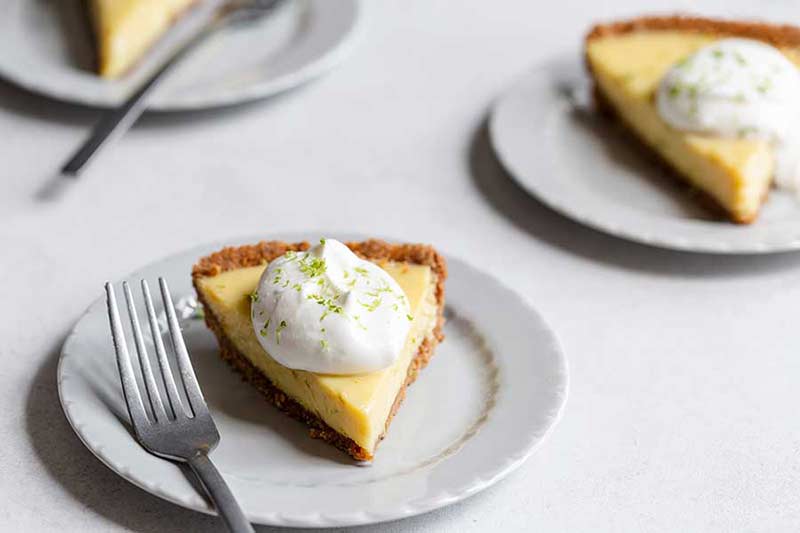 3 slices of key lime pie on plates