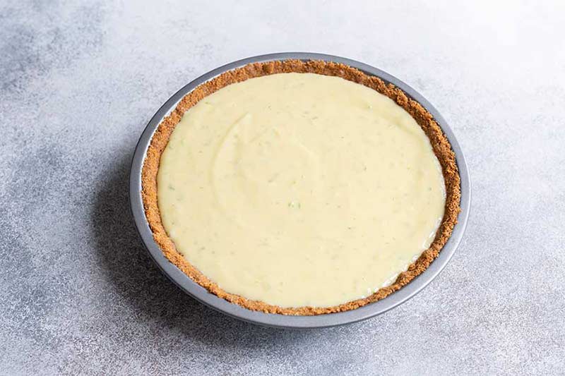 Key lime pie recipe filling poured into the graham cracker crust