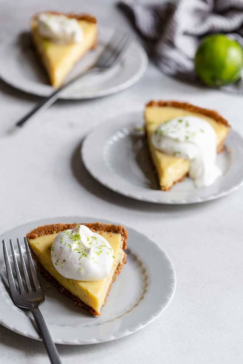 3 slices of key lime pie topped with whipped cream