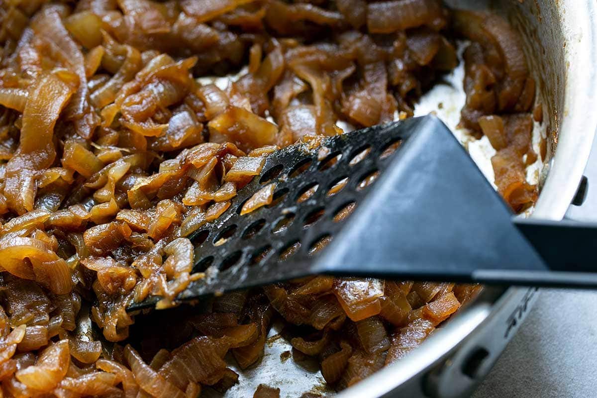 Using spatula to cook onions
