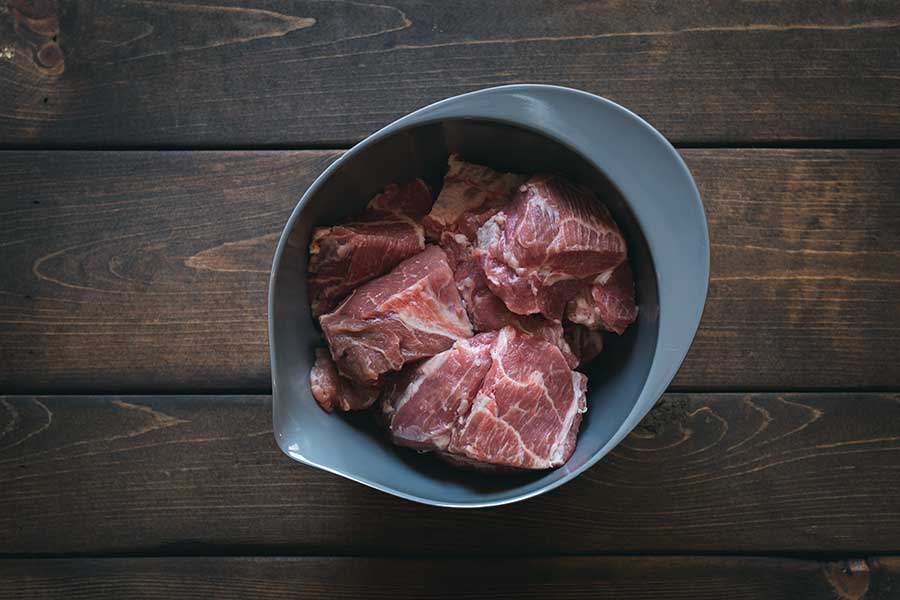Trimmed pork shoulder in a bowl