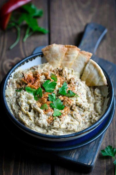 Baba Ganoush in bowl with pita chips on the side