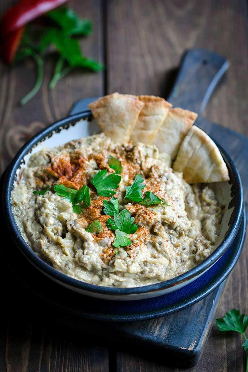 Baba Ganoush in bowl with pita chips on the side