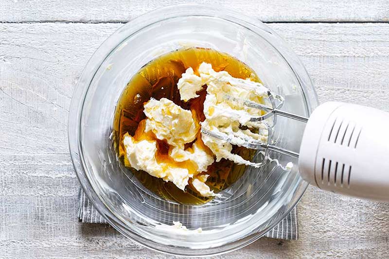 adding maple syrup to the bowl
