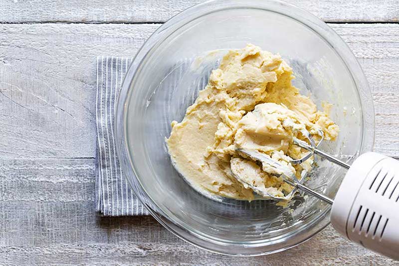 whipping the butter and syrup together until the ingredients are smooth