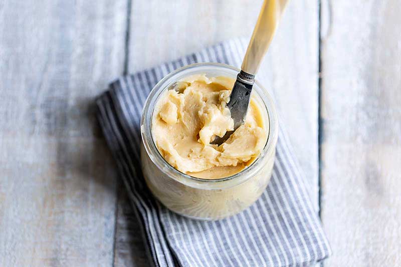 maple butter in a mason jar with a butter knife