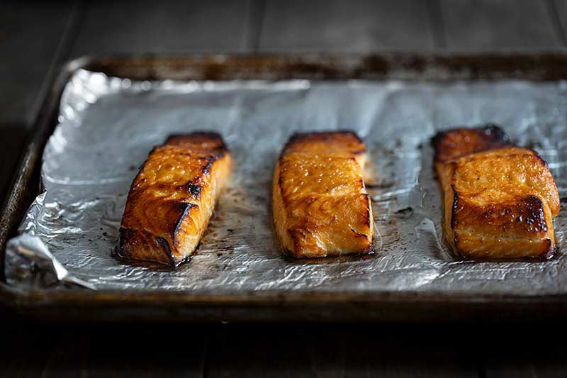 baked salmon on a sheet pan lined with foil