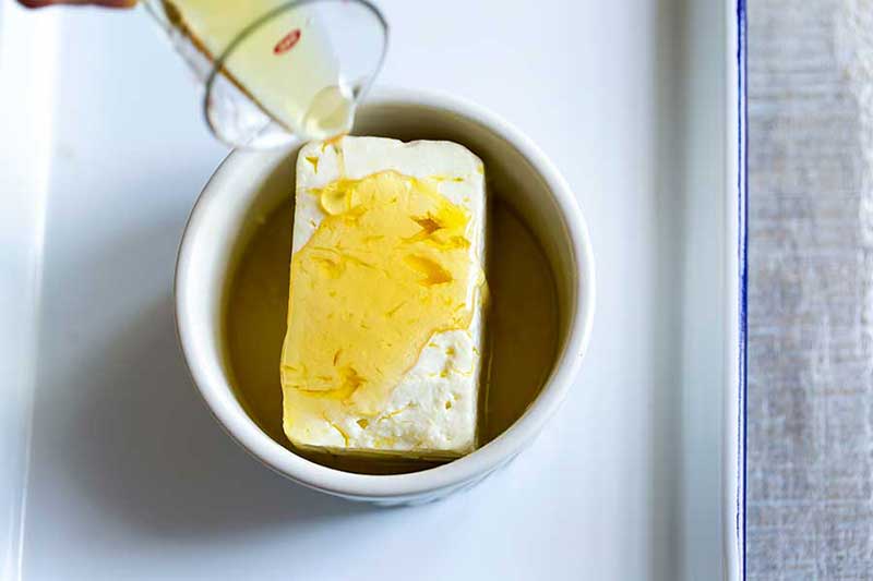 pouring honey over feta