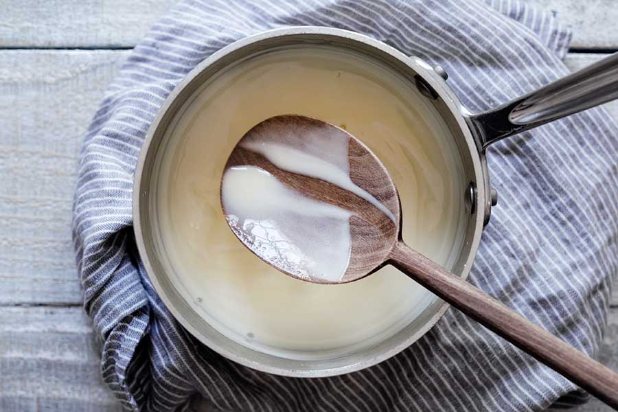Cooked ice cream base coating the back of a wooden spoon