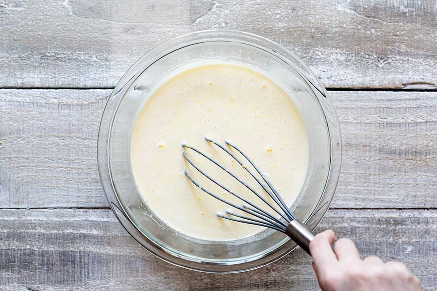 Tempering cream into the egg yolk mixture