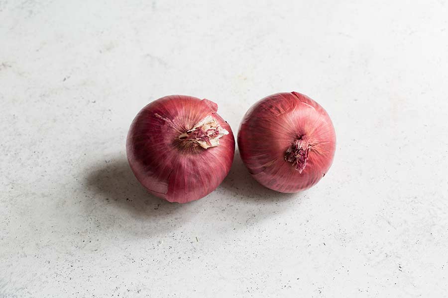 red onions on a white backdrop