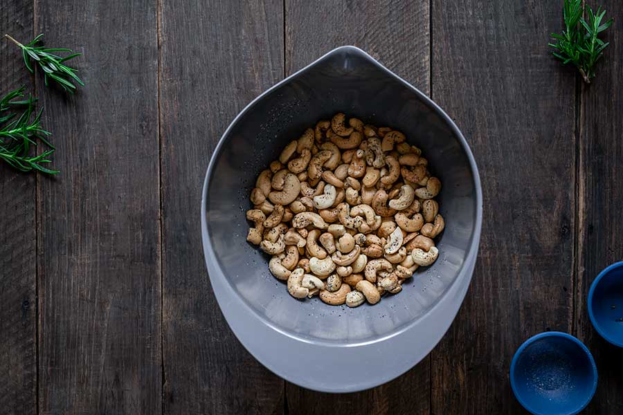 Rosemary salt-and-pepper toasted cashews tossed together in a bowl