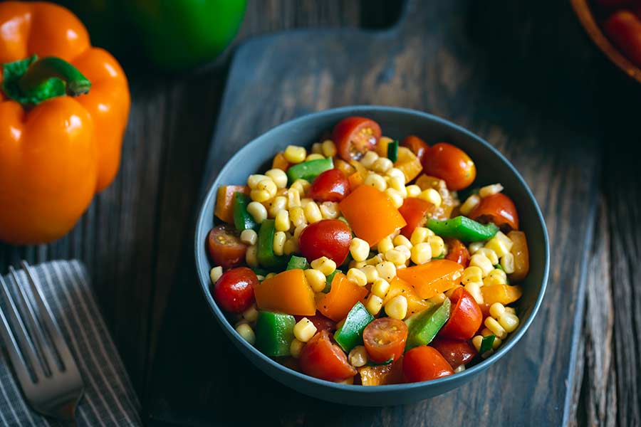 Corn salad in a grey bowl