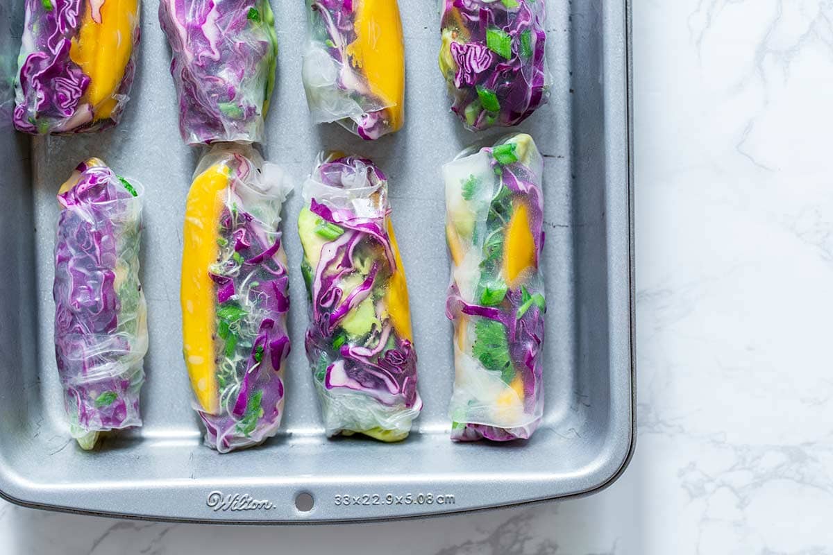 Many summer rolls in a lightly greased baking pan