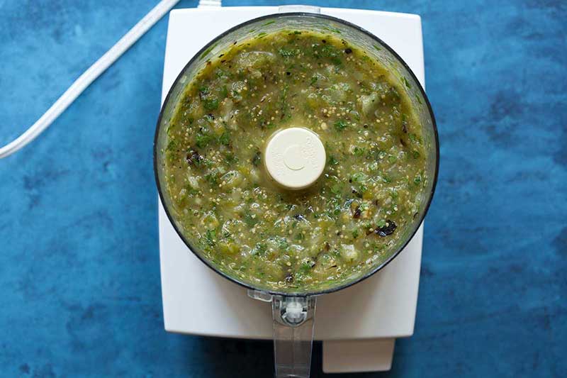 The finished salsa verde recipe in a food processor.