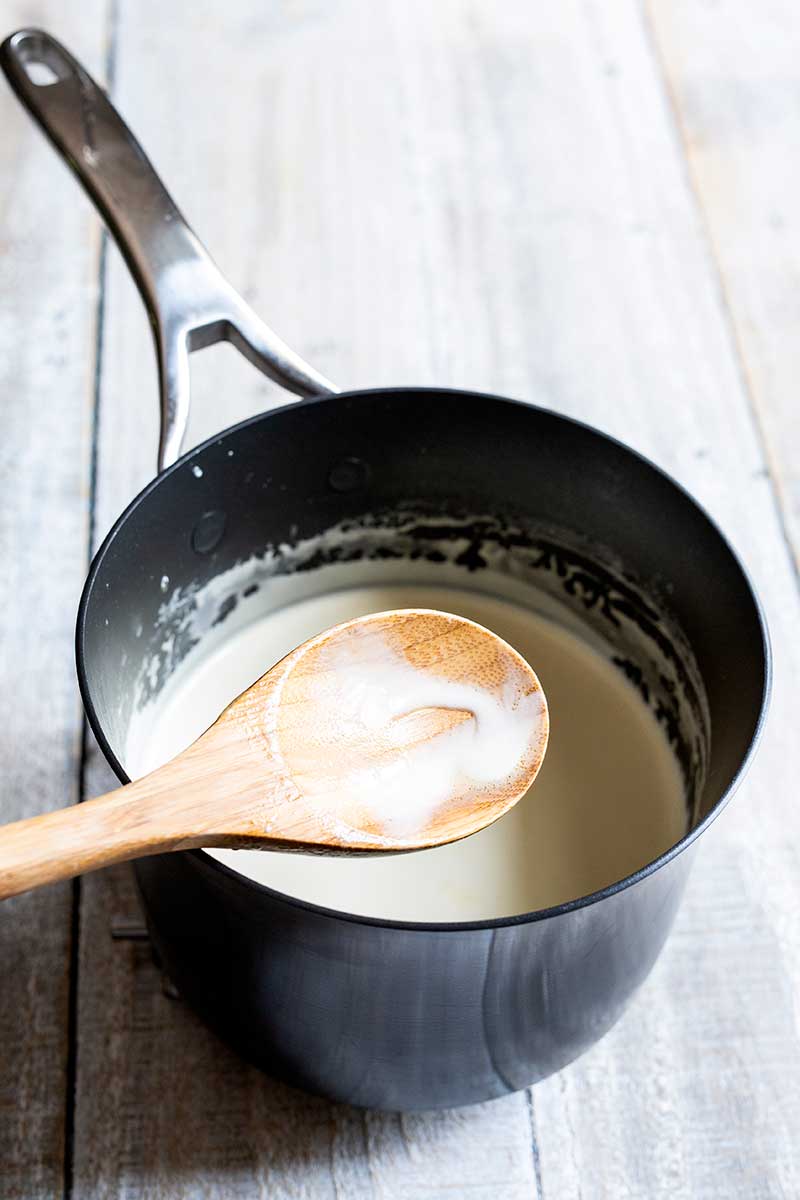 A wood spoon showing correct ice cream base thickness
