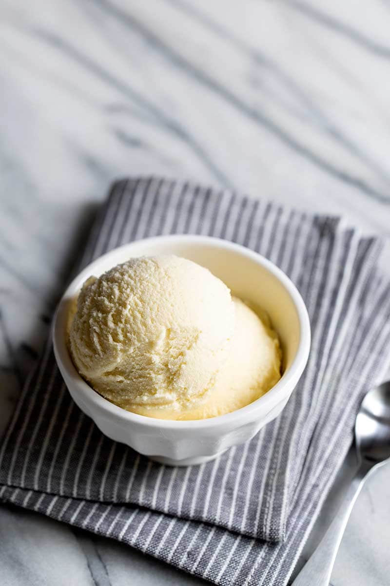 Homemade ice cream in a bowl on a marble backdrop