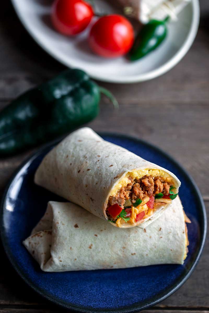 Closeup of finished, easy burrito recipe with the end sliced off to show filling
