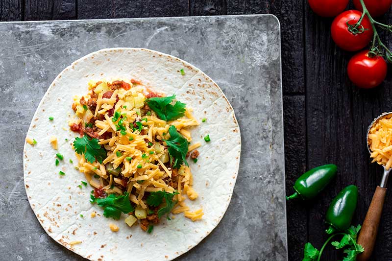 A flour tortilla topped with the chorizo breakfast burrito fillings