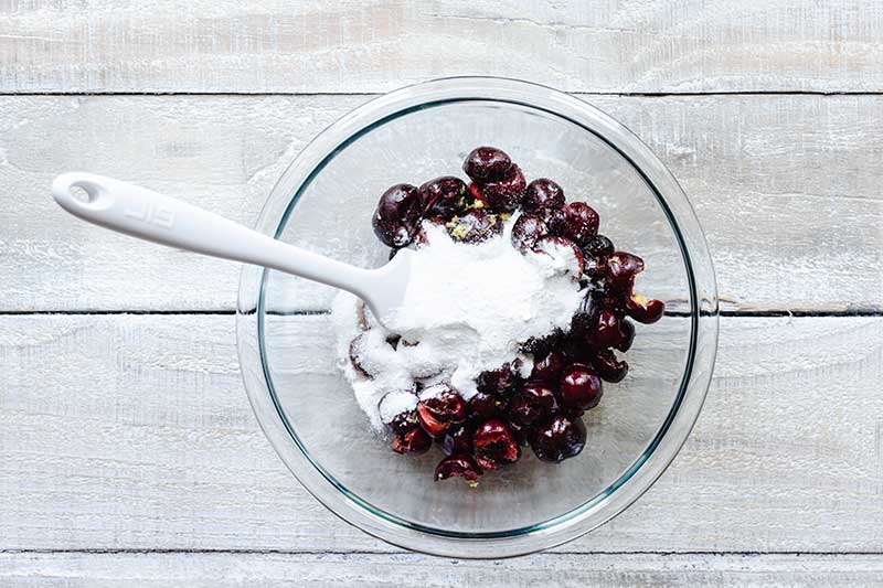 Cherry filling ingredients in a bowl with a spatula