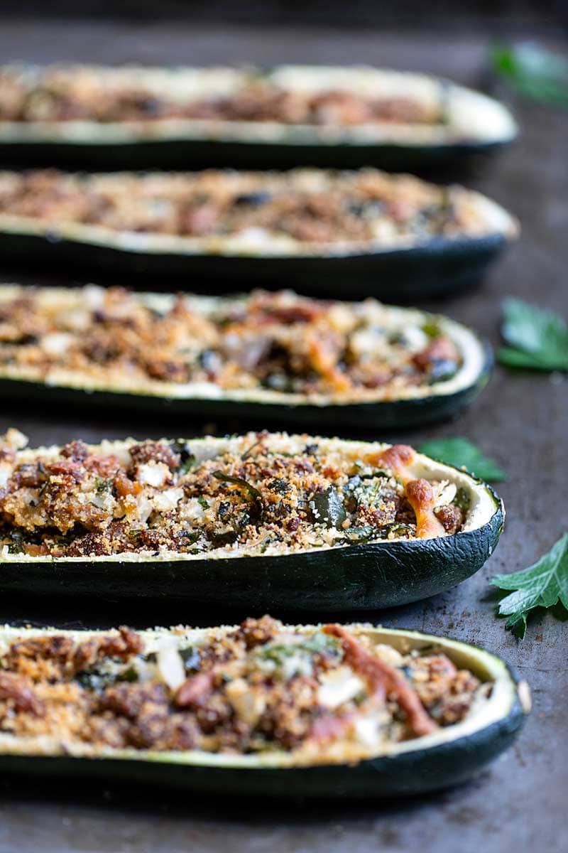 Side angle closeup of Italian sausage-stuffed zucchini boats recipe