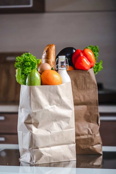 Pantry staples in two brown paper bags