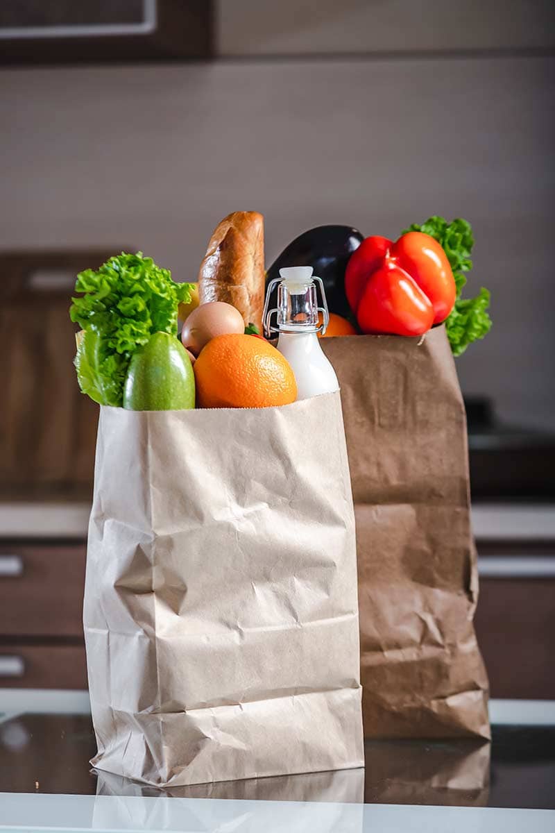 Pantry staples in two brown paper bags