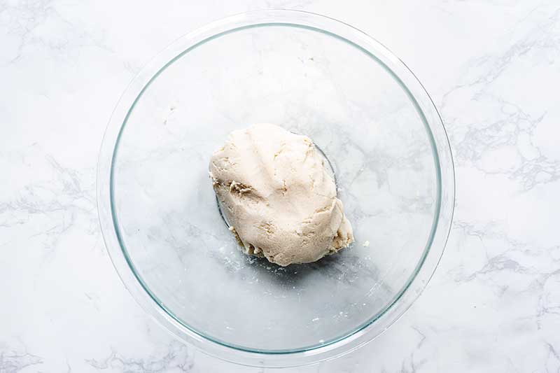 smooth corn tortilla dough in a bowl after kneading for several minutes