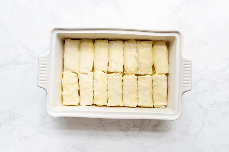 14 cheese blintzes packed into a single layer in a casserole dish