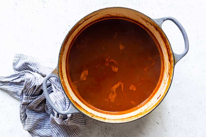 Braising liquid reduced to a thicker consistency with a small layer of fat floating on top