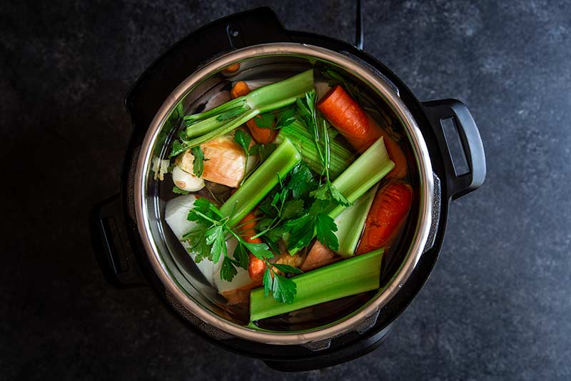 celery, onion, carrots and water in an Instant Pot
