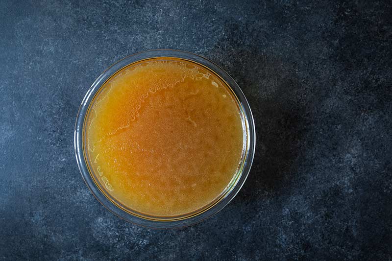 bowl of homemade chicken broth made from scratch