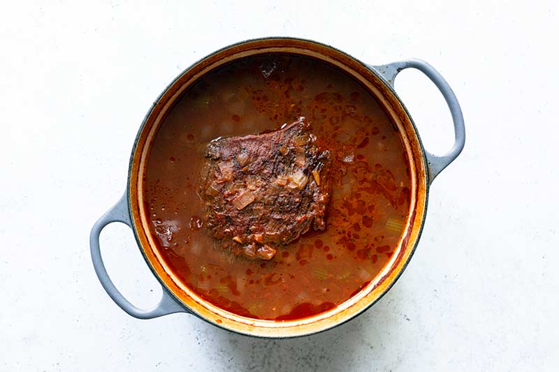 Braised beef brisket just out of the oven, still in the sauce