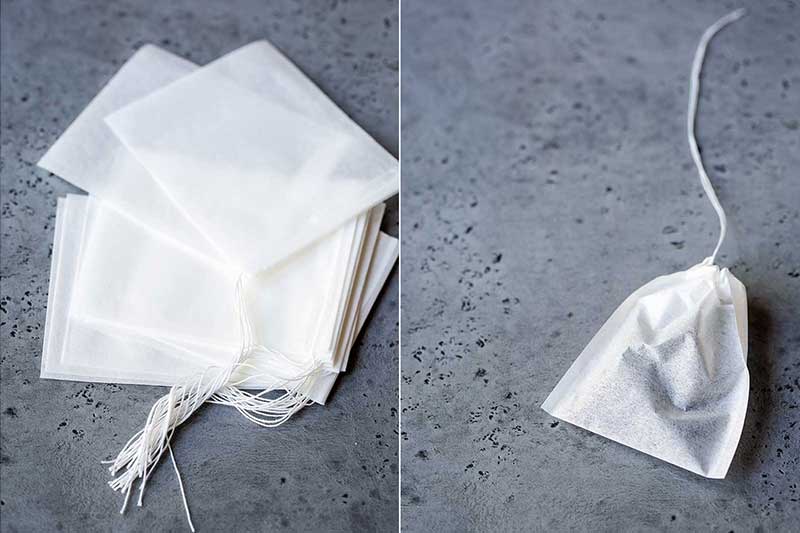 empty drawstring tea bags on left, a sealed tea bag on right
