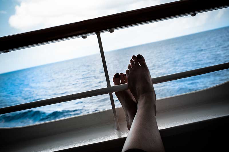 feet leaning up against the balcony