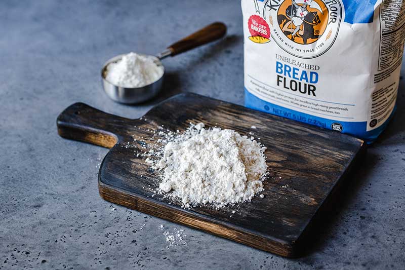 bread flour on a cutting board next to the package