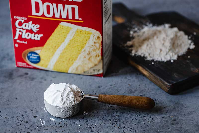 cake flour in a measuring cup next to the package