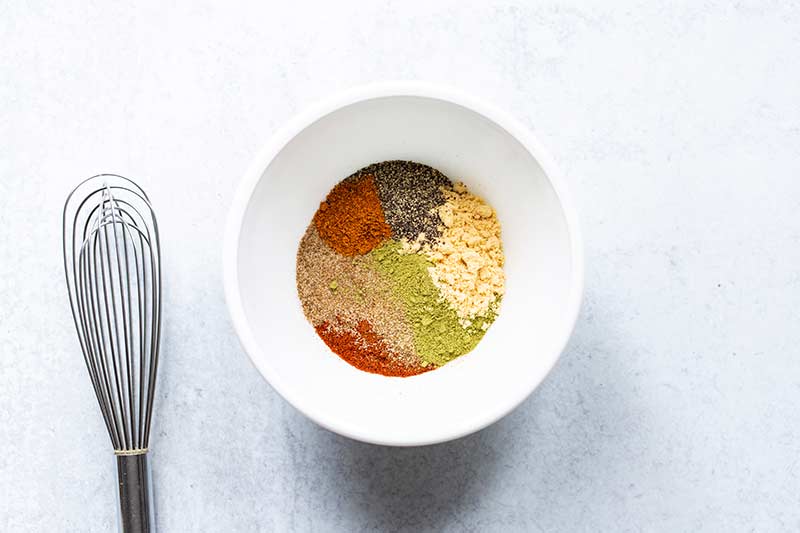 A bowl with unblended spices for old bay recipe ingredients