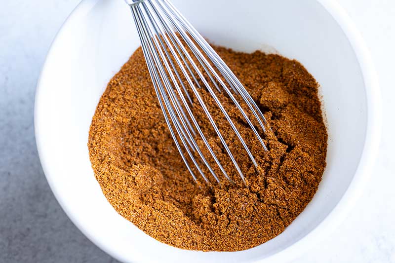 close up of homemade spice blend and whisk