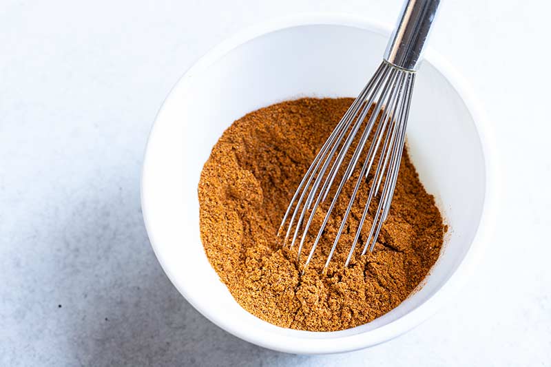 homemade old bay seasoning in a bowl blended with a whisk